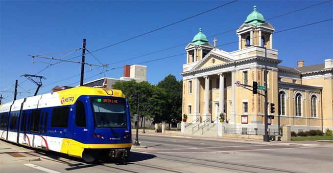 Light rail train passing Christ on Capitol Hill Church where Daily Work is located