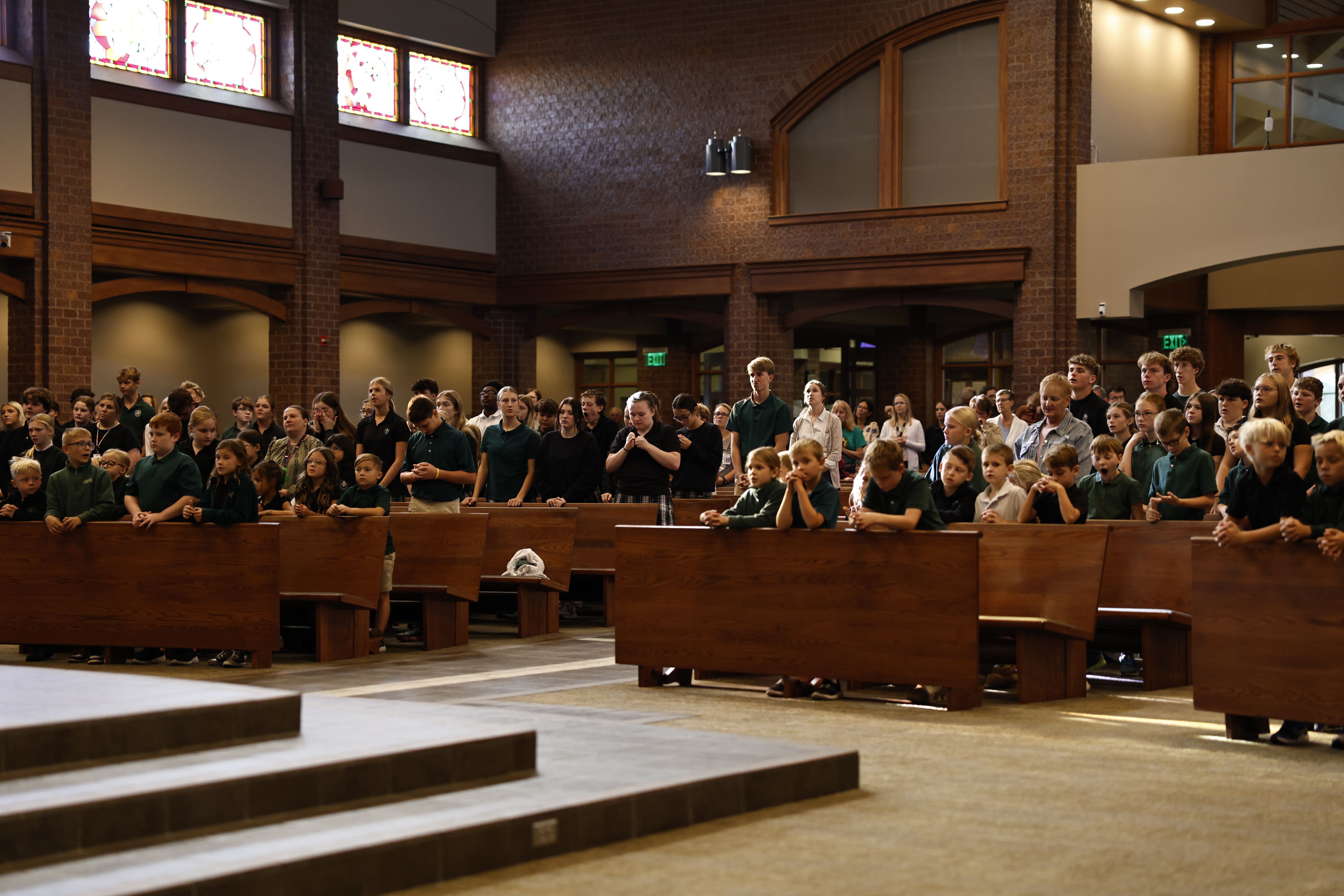 Elementary students participating in a worship service