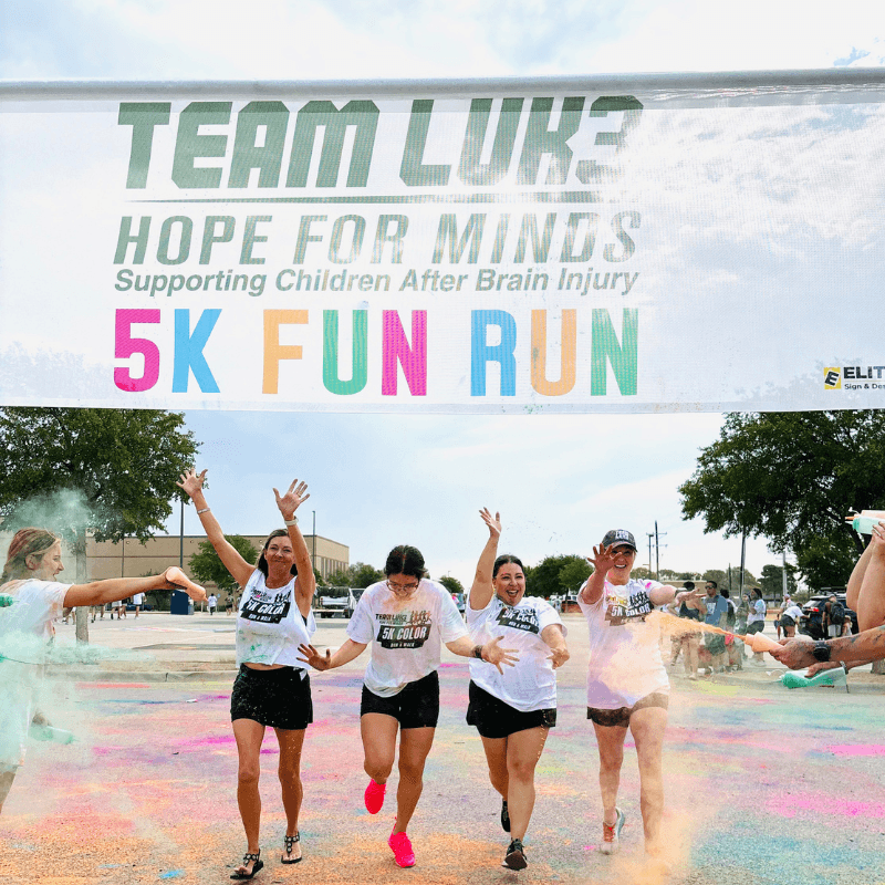 4 girls running in the Team Luke Hope for Minds Color Run 