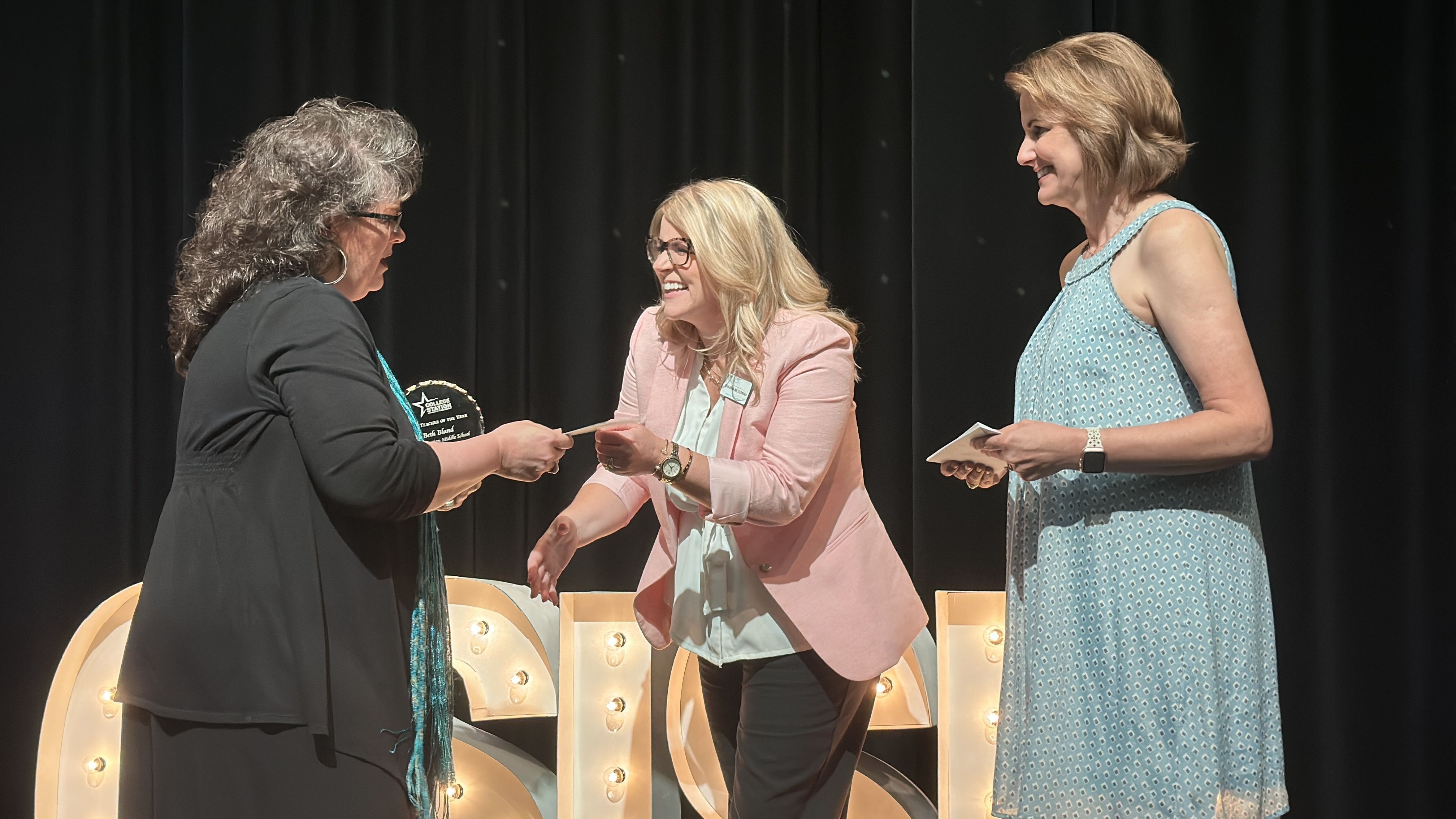 Employee receiving a check from sponsor