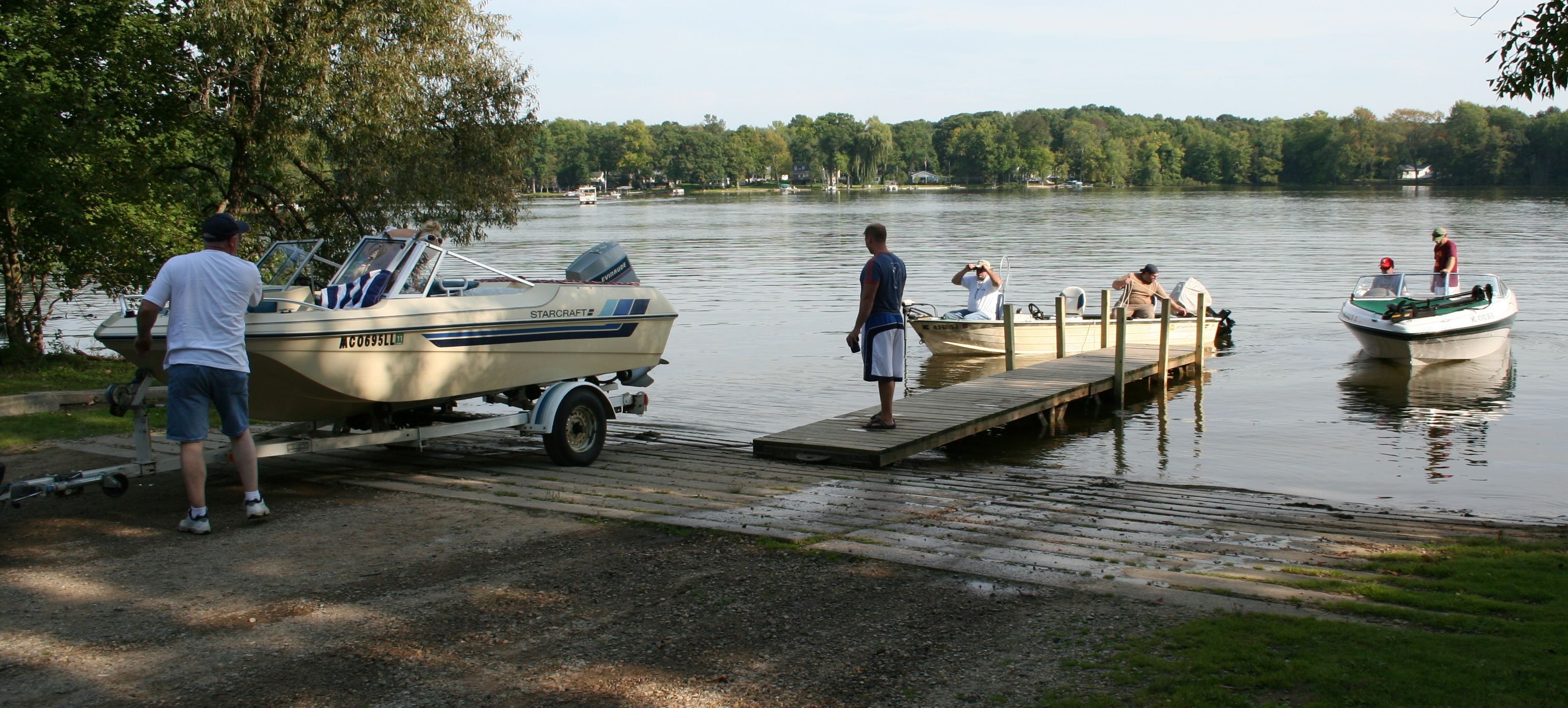 Public boat launch with two boats at the dock. 