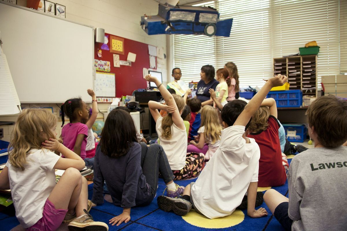 classroom of kids sitting on the floor at story time