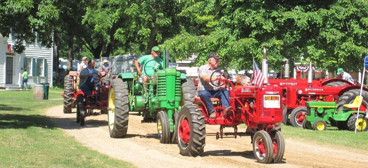 Red and green tractors parade through the historic village.