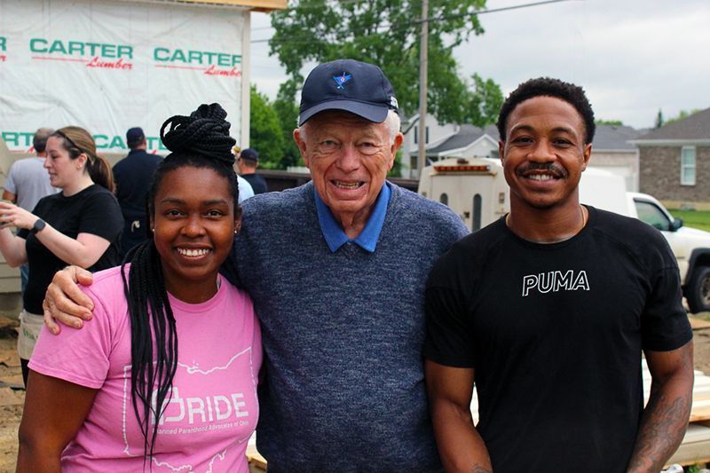 Charles Simms and Homebuyers Kendra and Donnovan at the Ann Simms Memorial Women Build site.