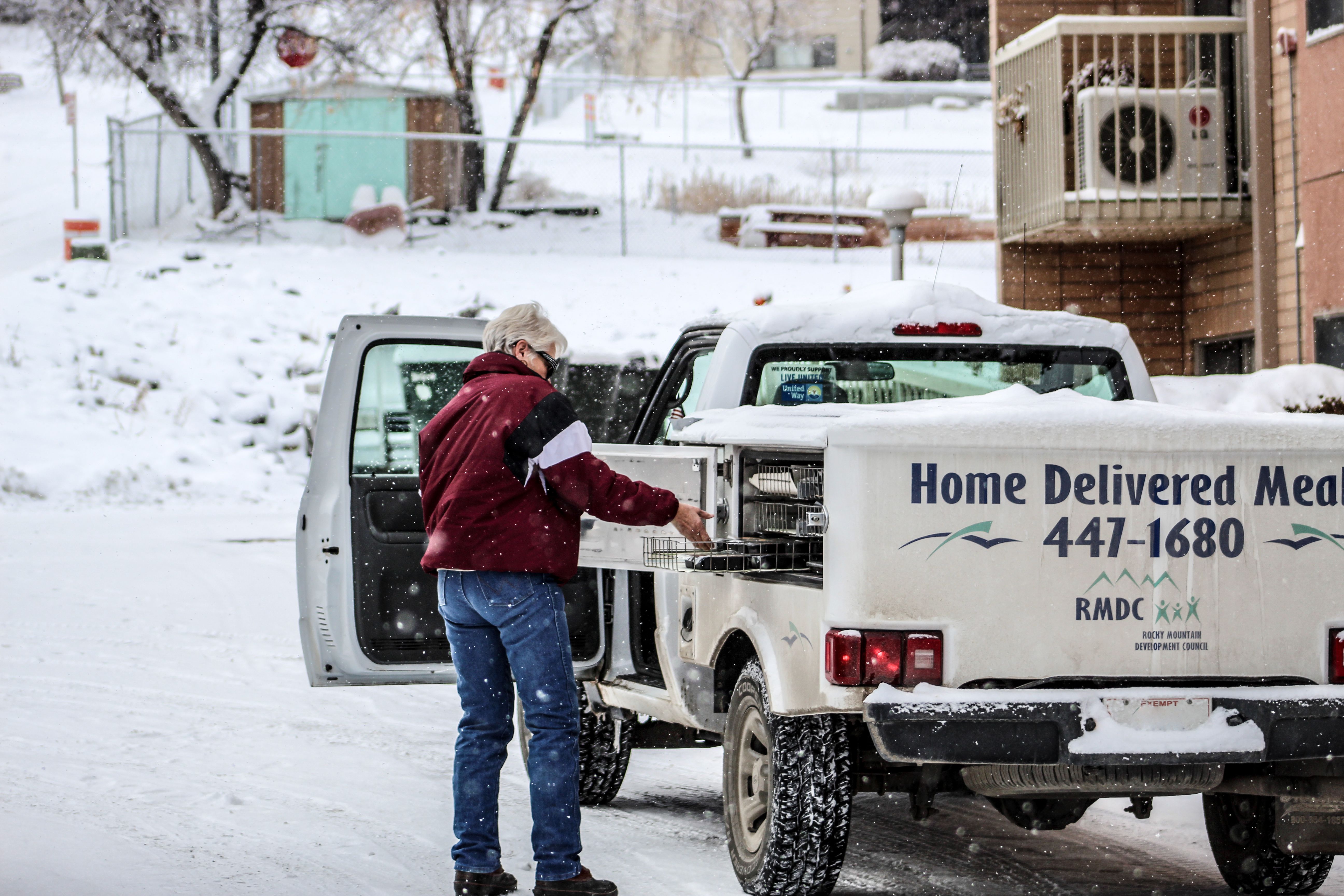 Pictured: Meals on Wheels driver, Duzzy, delivering meals on a snowy, winter day. 