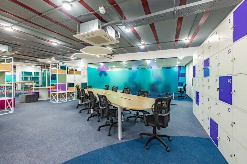 Blue frosted glass partitions providing conference room privacy while serving as sleek architectural elements for modern office branding ideas.