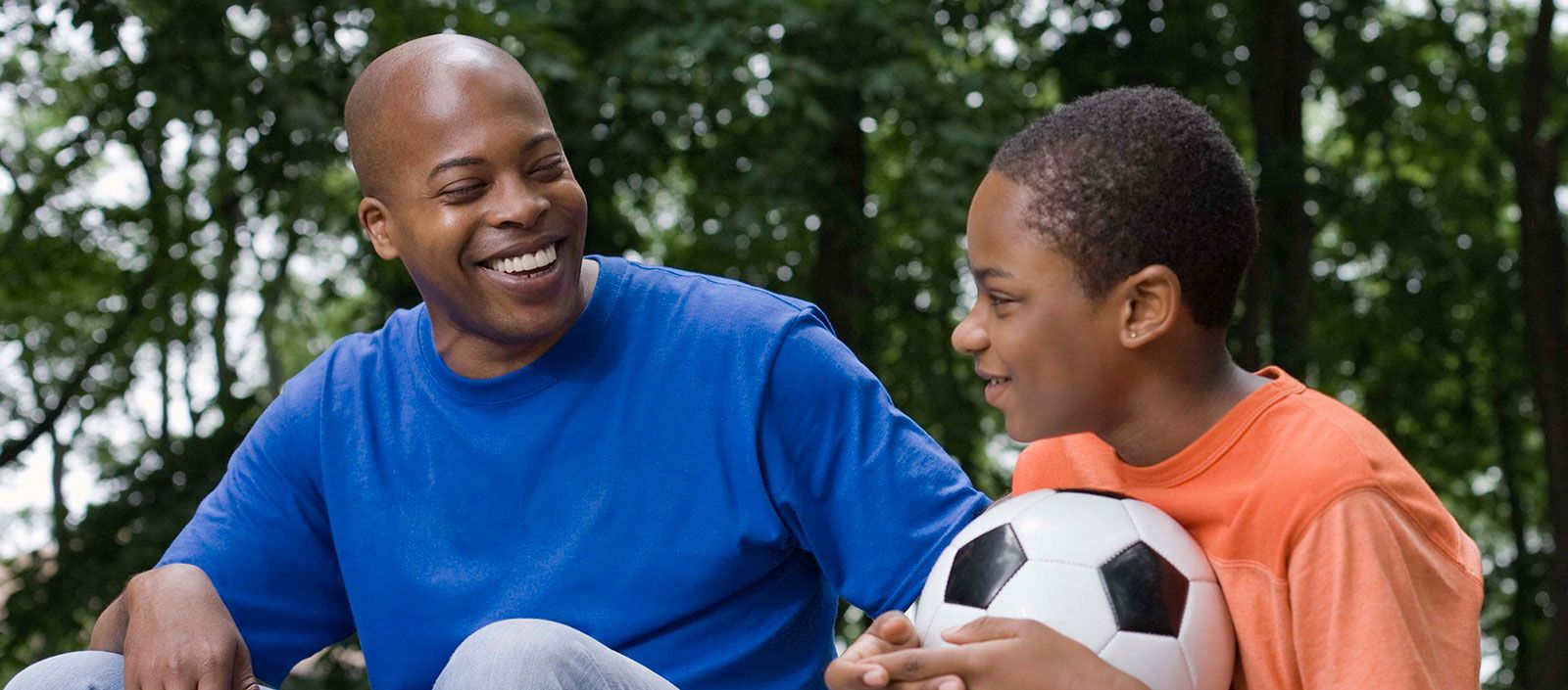 Young boy laughing with his CASA volunteer