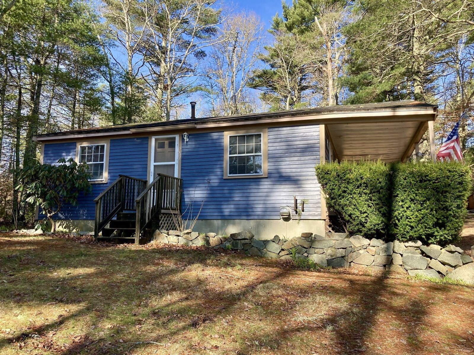 A photo of the front of a blue house, before Habitat's renovation