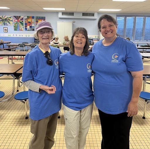 Smiling volunteers in the classroom