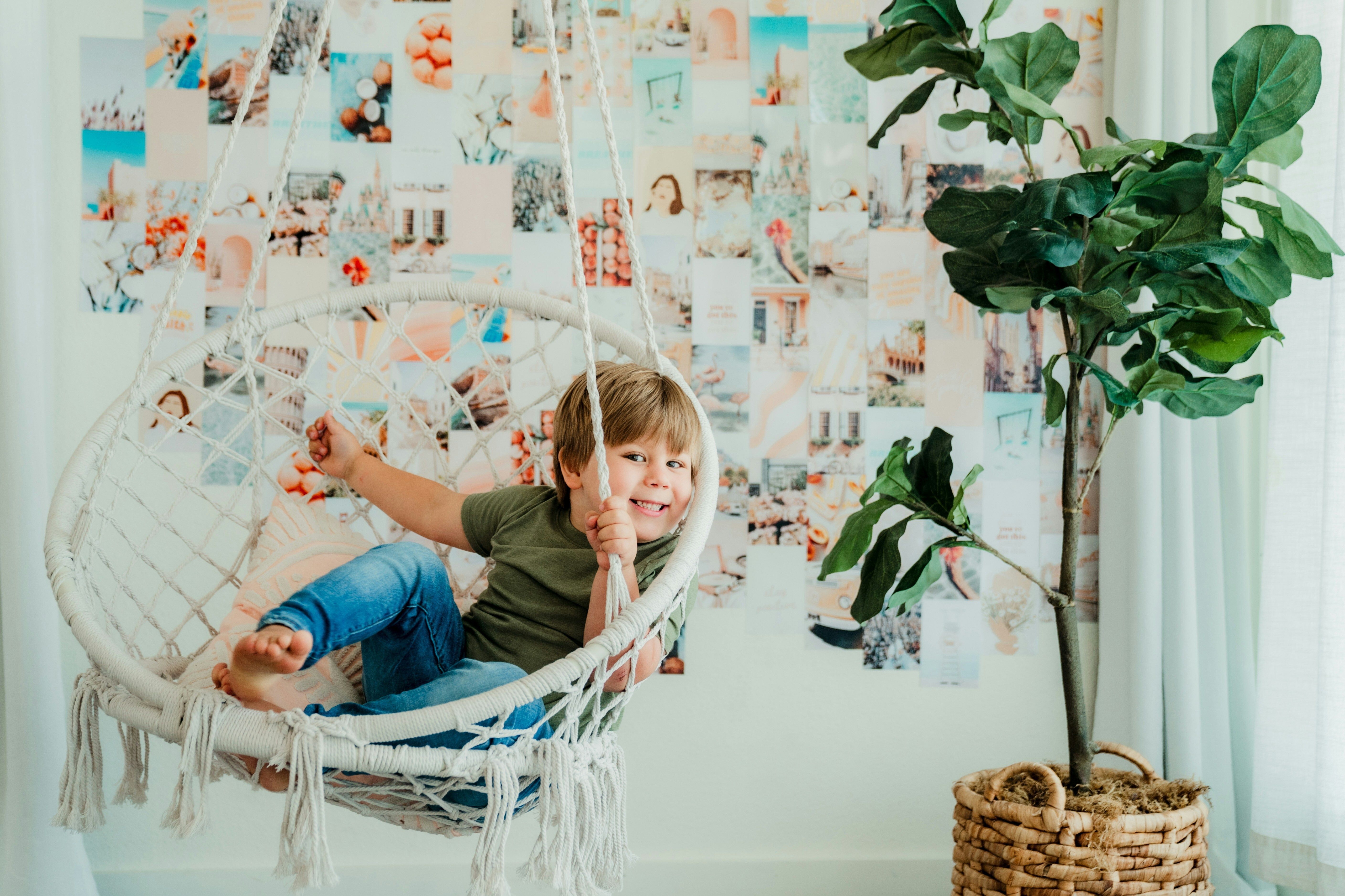 Kid hiding between two trees.