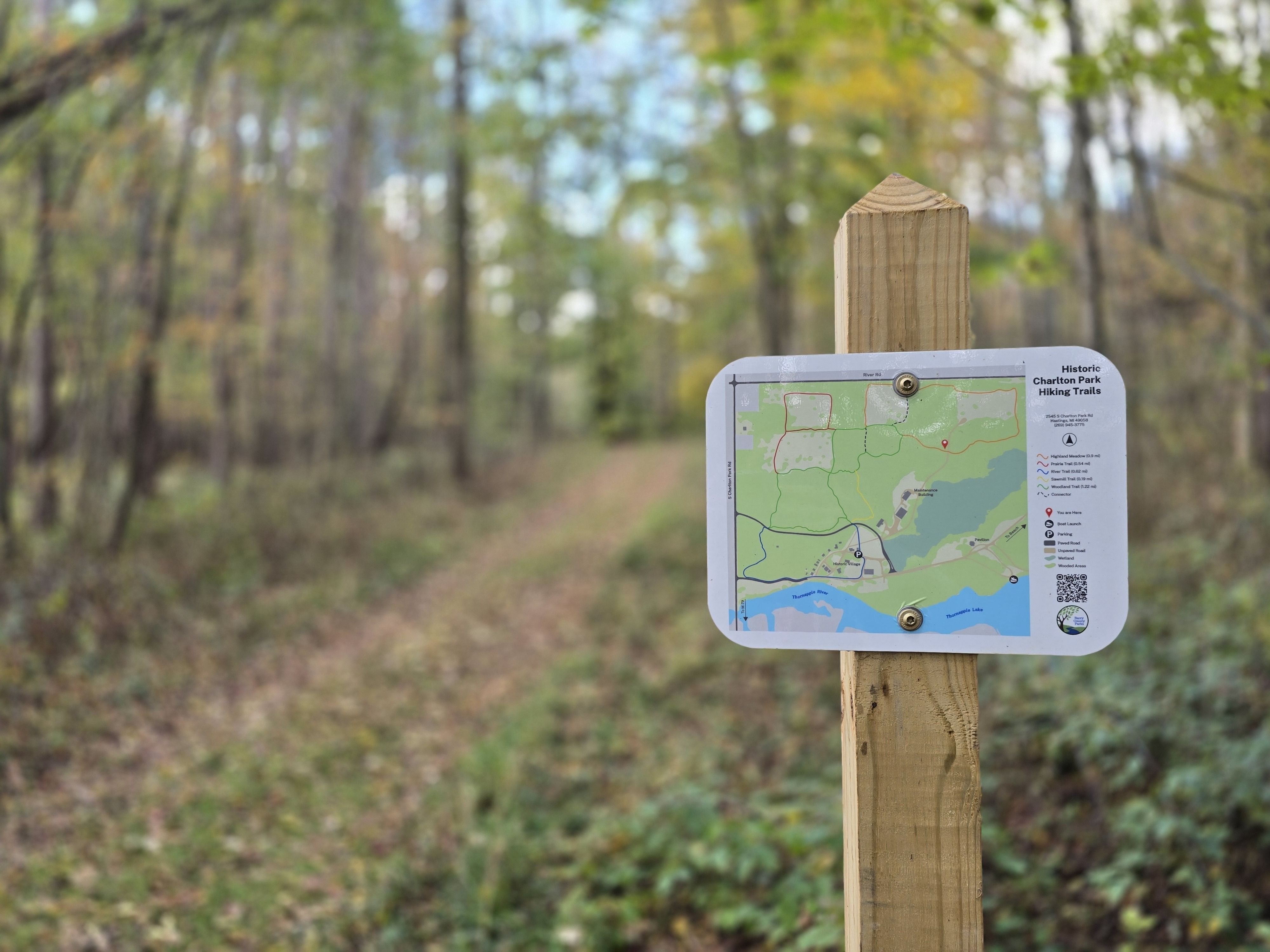 Trail map with a trail in the background.