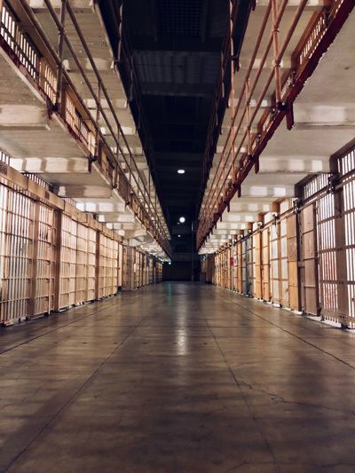 Long dimly lit corridor of a jail.