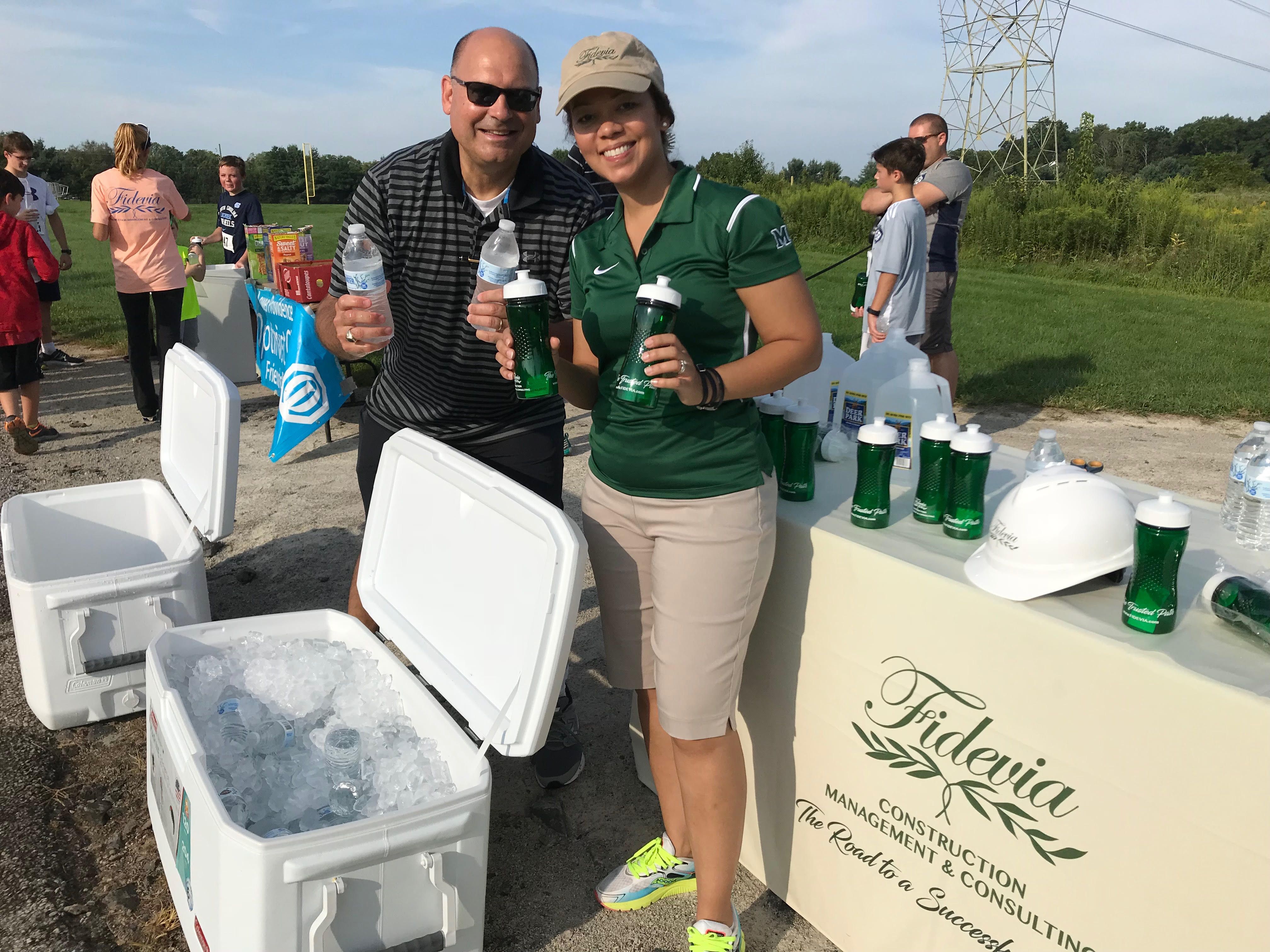 Fidevia Hands Out Water to Runners at 5K
