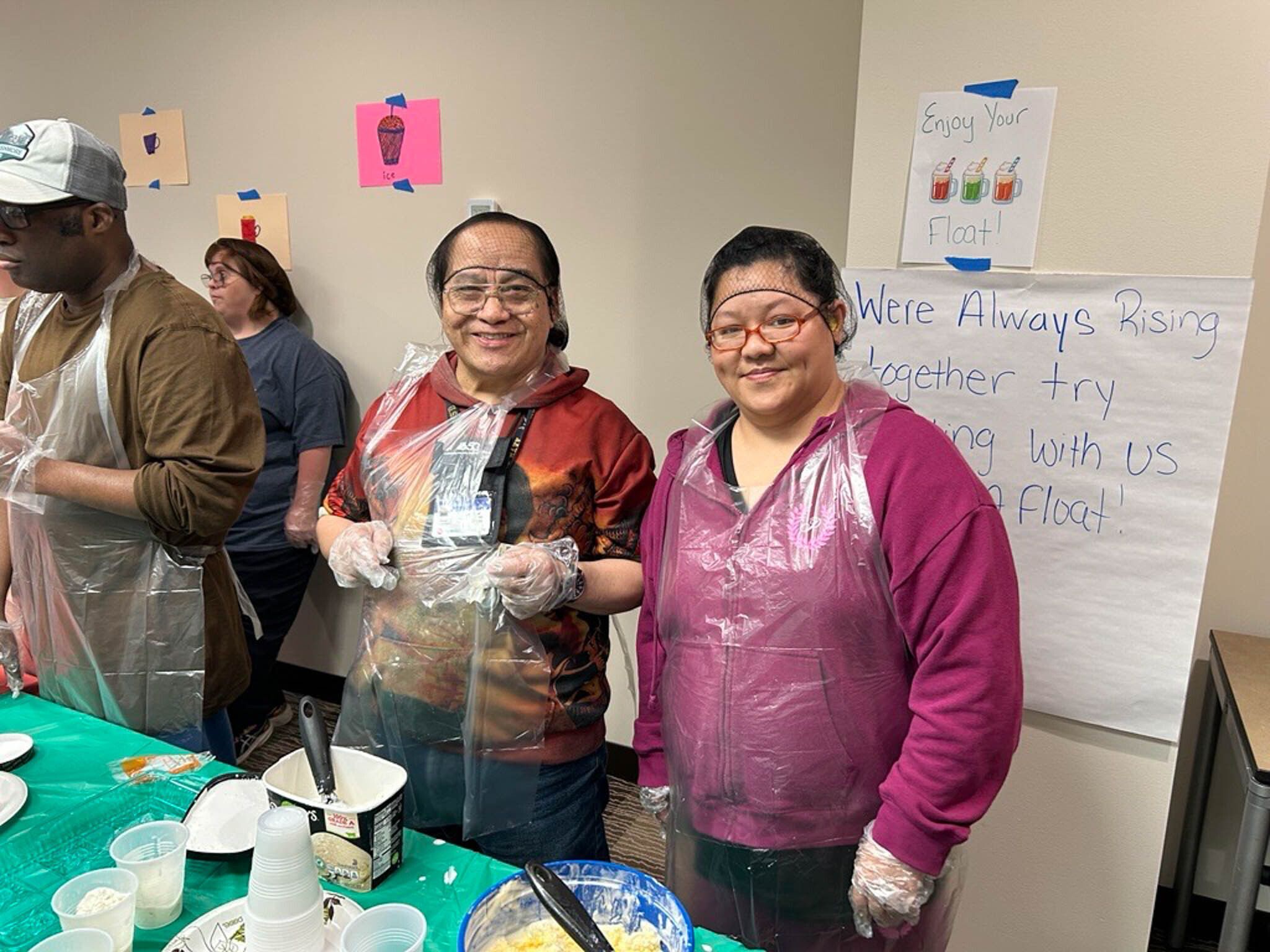 Two participants in Rise's Restaurant Ready program serve ice cream floats as part of their immersive simulation