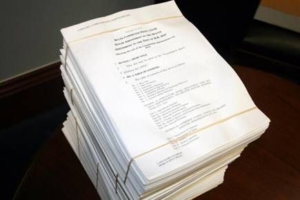 An image of the stack of papers for the increased funding request.