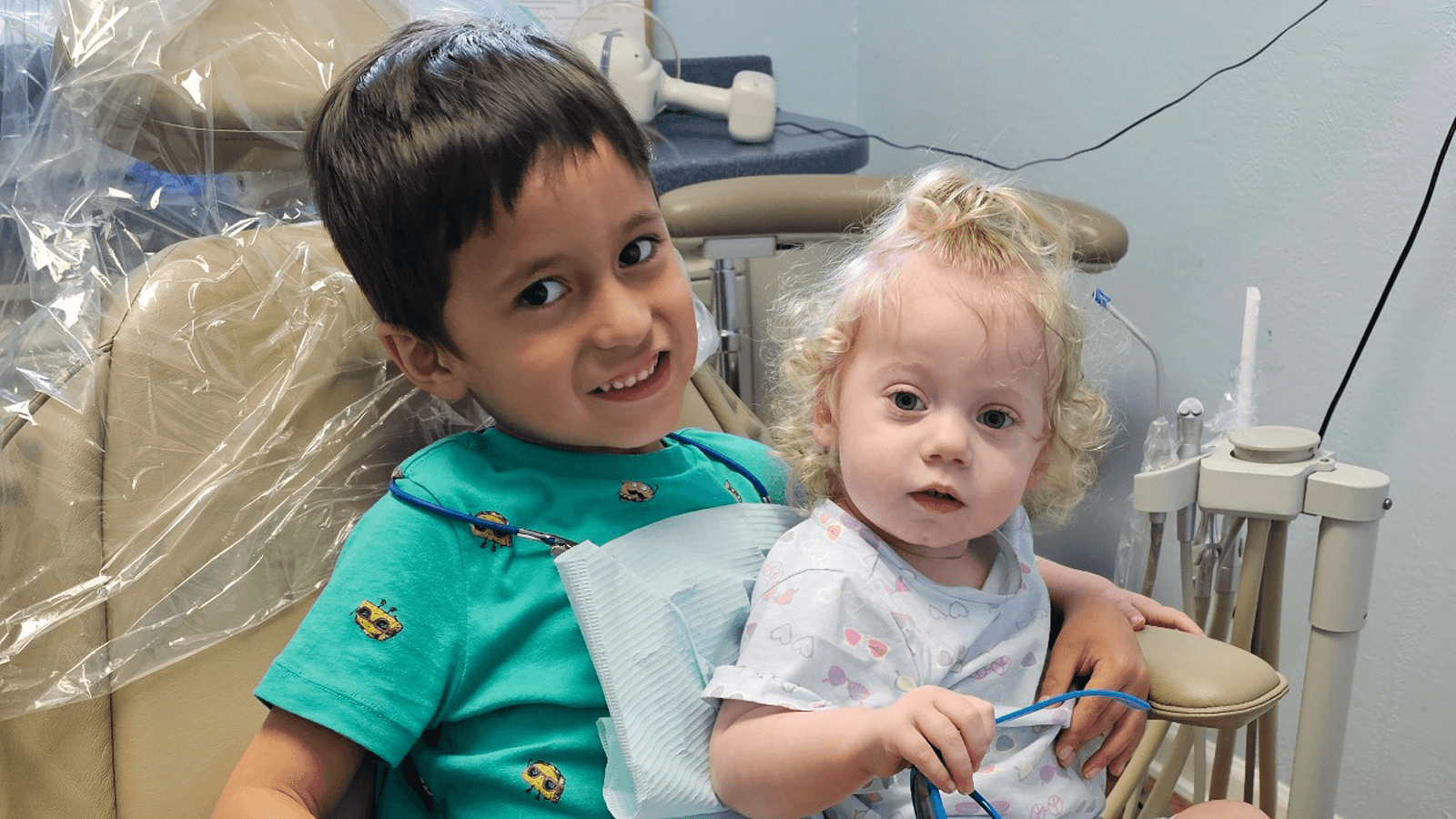 boy and toddler in dentist chair