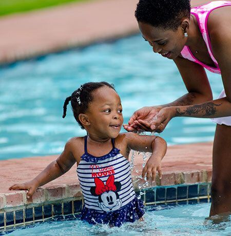 Mother and child playing in swimming pool