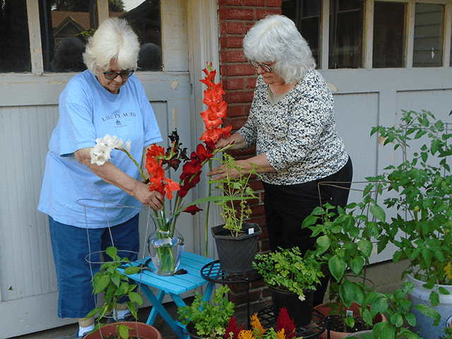 Celebrate Mary—Oblates Marlene Trambley and Kathleen Pae gather flowers to celebrate Mary.