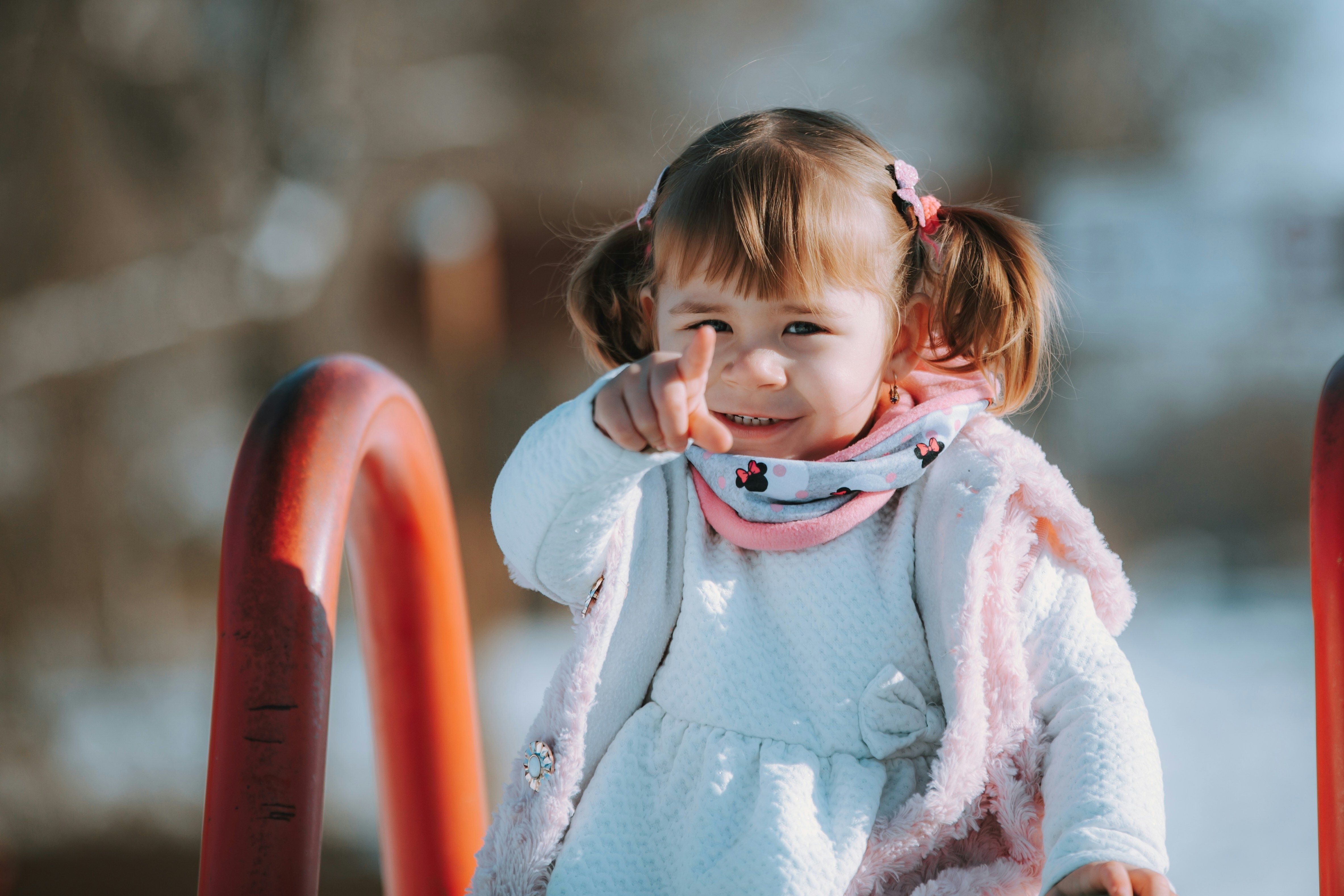young boy on a swing with a blue sky