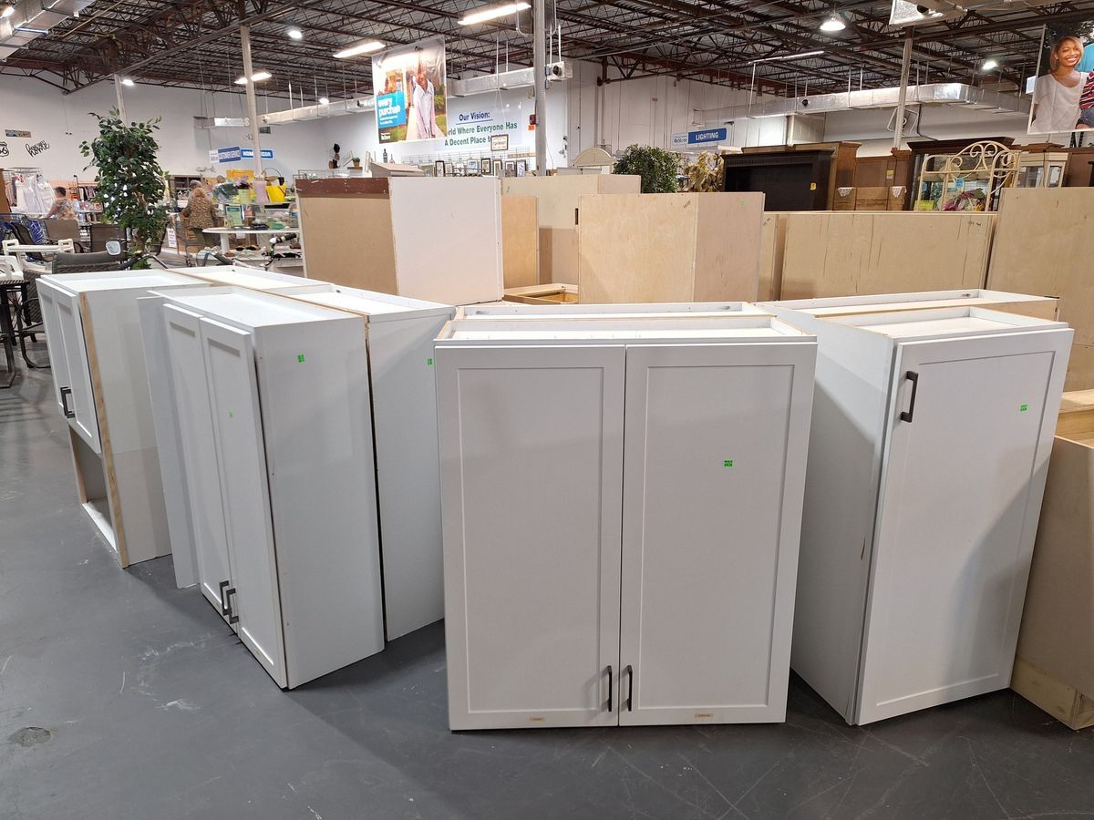 Selection of white shaker-style kitchen or bath cabinets in various sizes for sale at Habitat ReStore Zephyrhills
