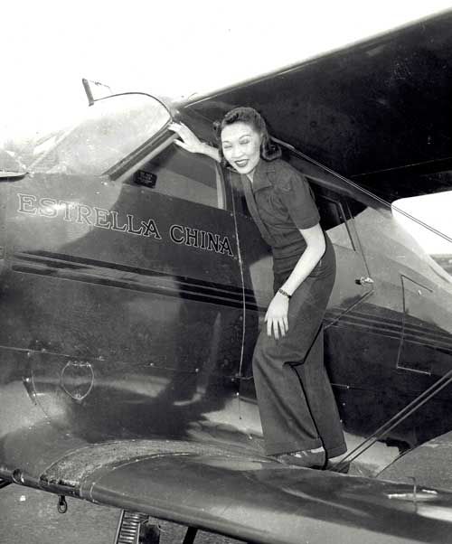 Lee Ya-Ching stands on the lower wing of a Beechcraft ‘Estrella China’, Roosevelt Field, L.I. 1940