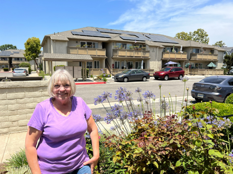 Emerald Cove resident Gerry Payton in front of solar panels