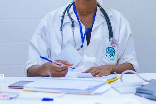 Physician writing a prescription