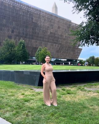 Women poses in front of museum