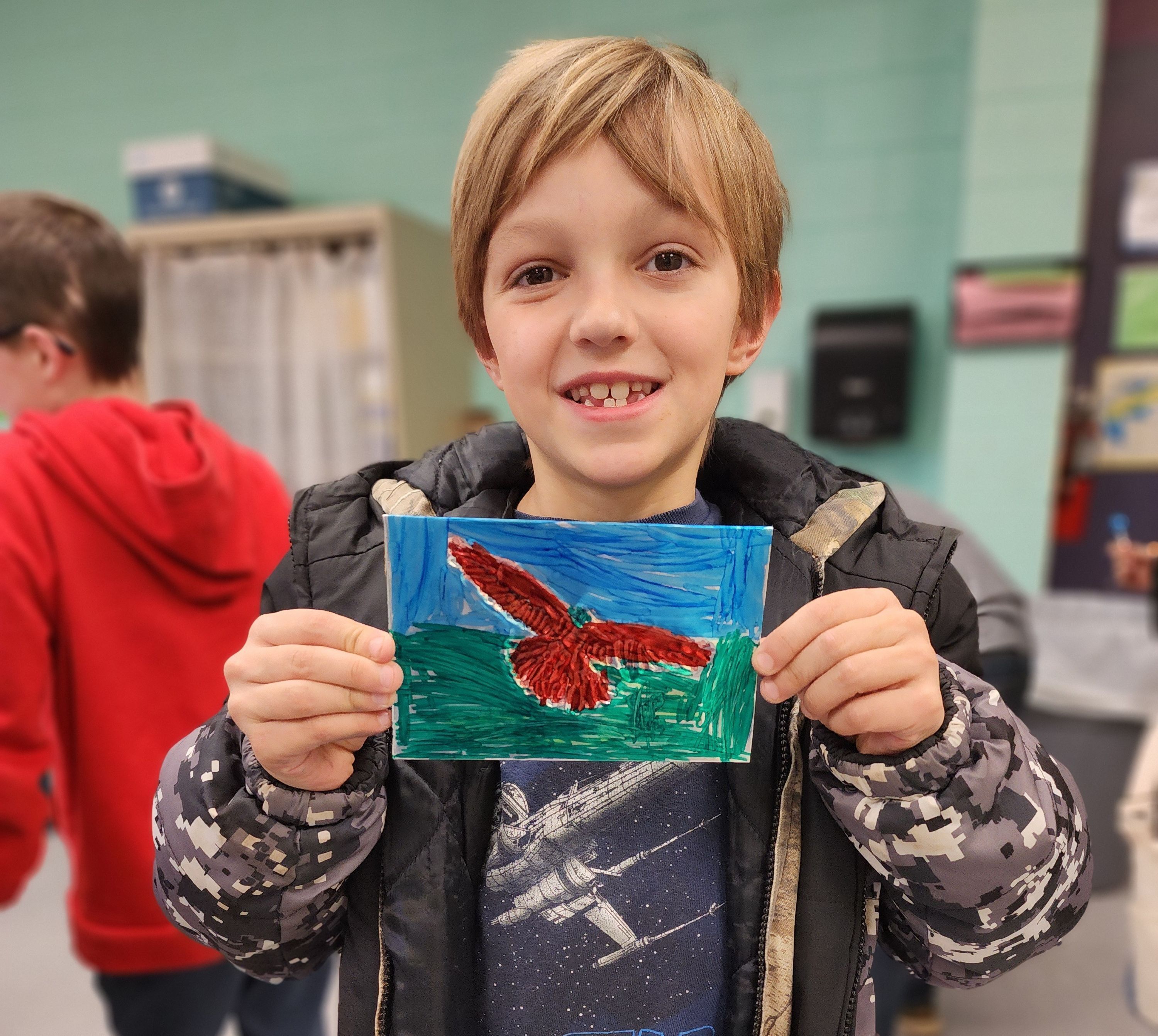 Excited student displaying jeweled foil artwork