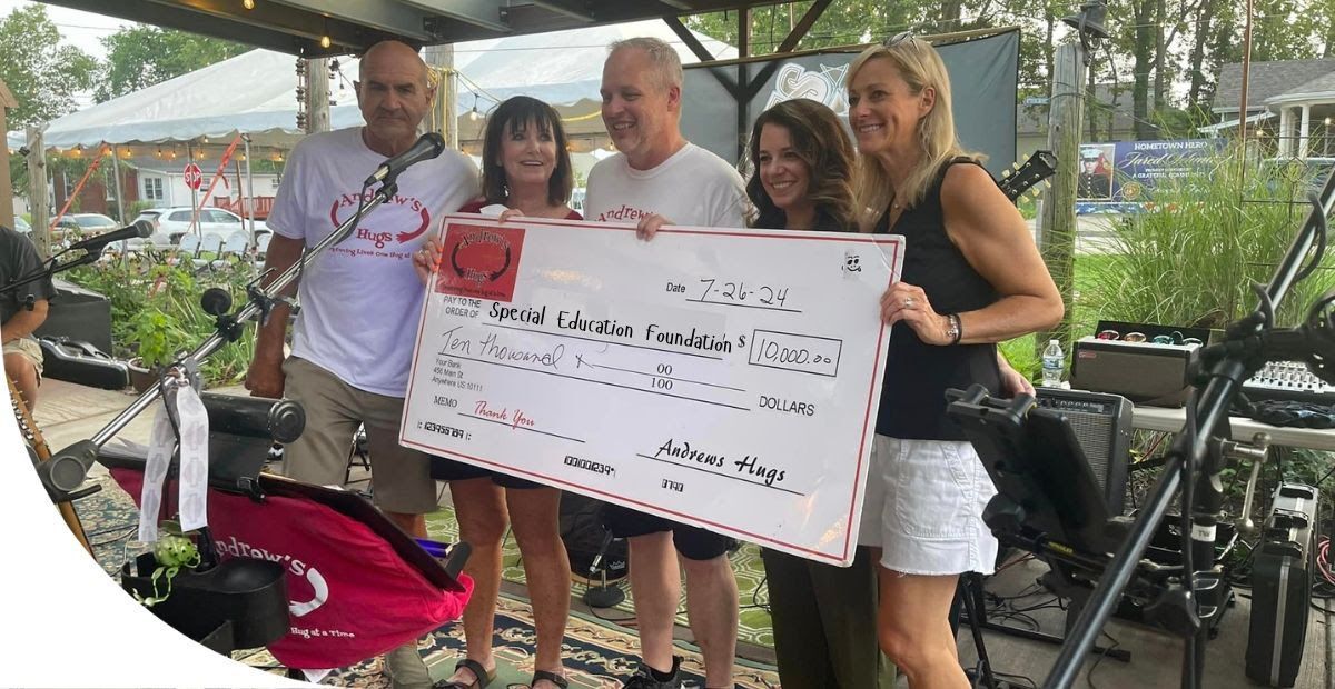 adults holding a check for $10,000