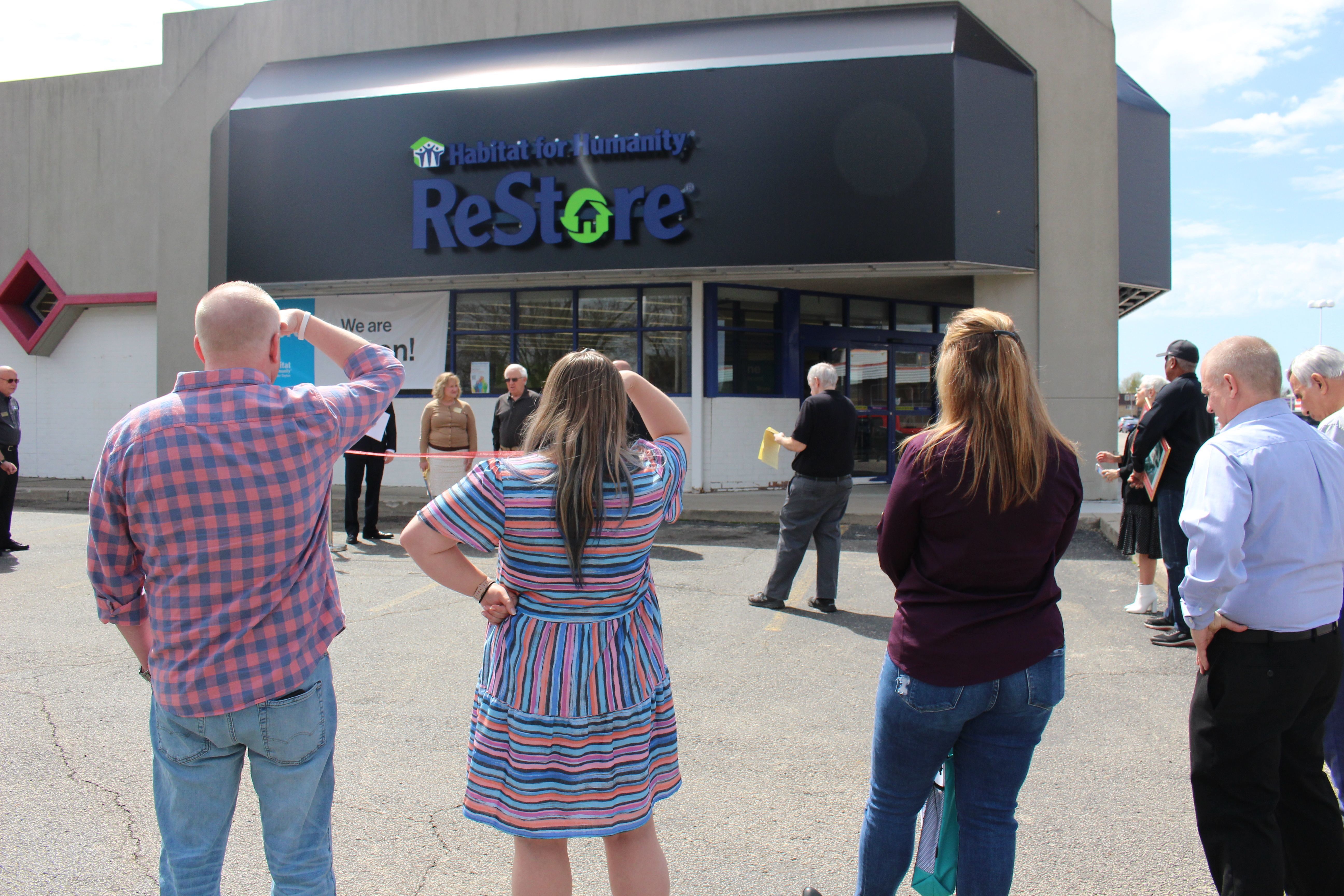 Crowd watches ribbon cutting in front of Springfield OH Habitat for Humanity ReStore