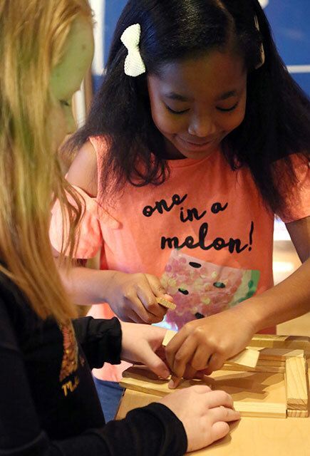 Two girls working on a puzzle.