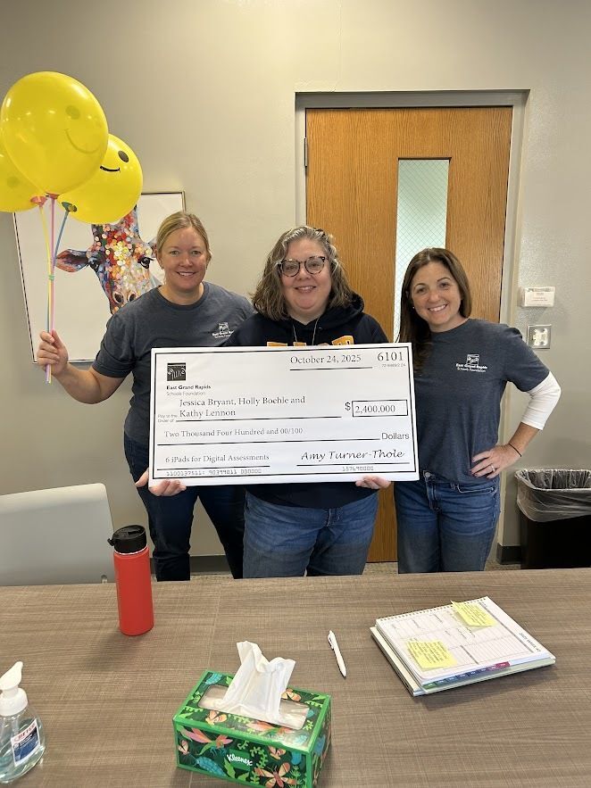 foundation board members and school psychologist with big check