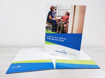 Full-color pocket folder with business card slits printed for AdventHealth.