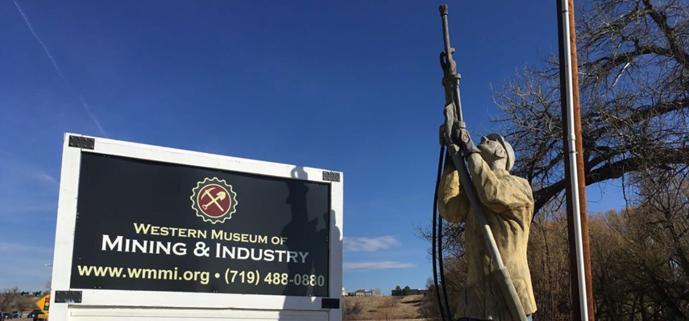 Western Museum of Mining and Industry front logo sign with statue.
