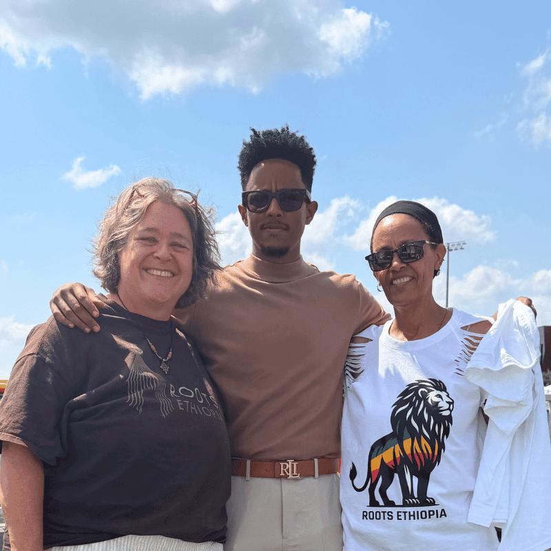 Meghan Walsh and Board Member Kongit with Adonay, Ethiopia's number one influencer, at the Roots Ethiopia booth on the opening morning of ESFNA 2026, TCO Stadium, Eagan, Minnesota