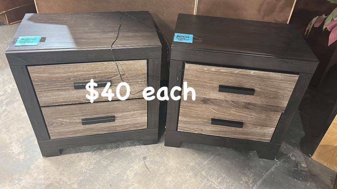 Set of two modern wood nightstands with black trim and dual drawers, available at Habitat ReStore Zephyrhills for $40 each