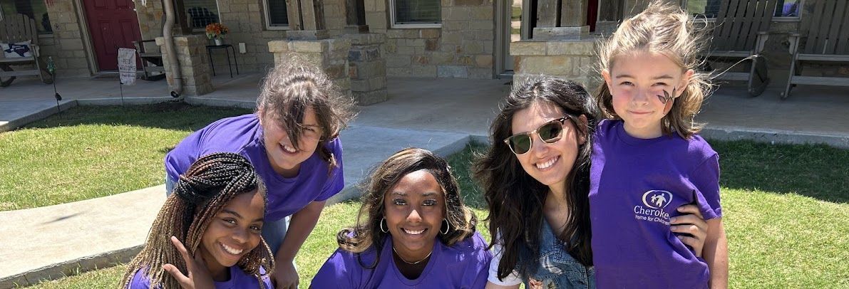 Girls in front of cottage