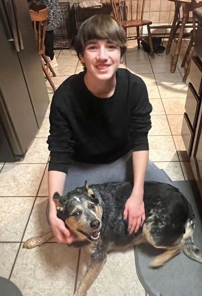teenage boy smiling with dog