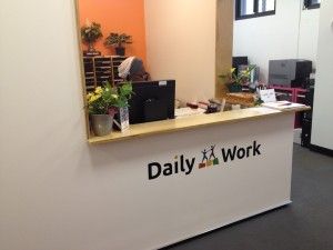 Bright, cheerful Daily Work reception desk welcomes visitors