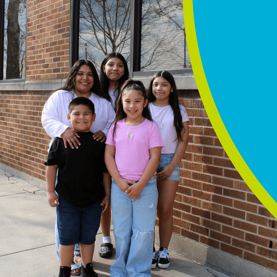 A mother with her 4 smiling kids standing outside