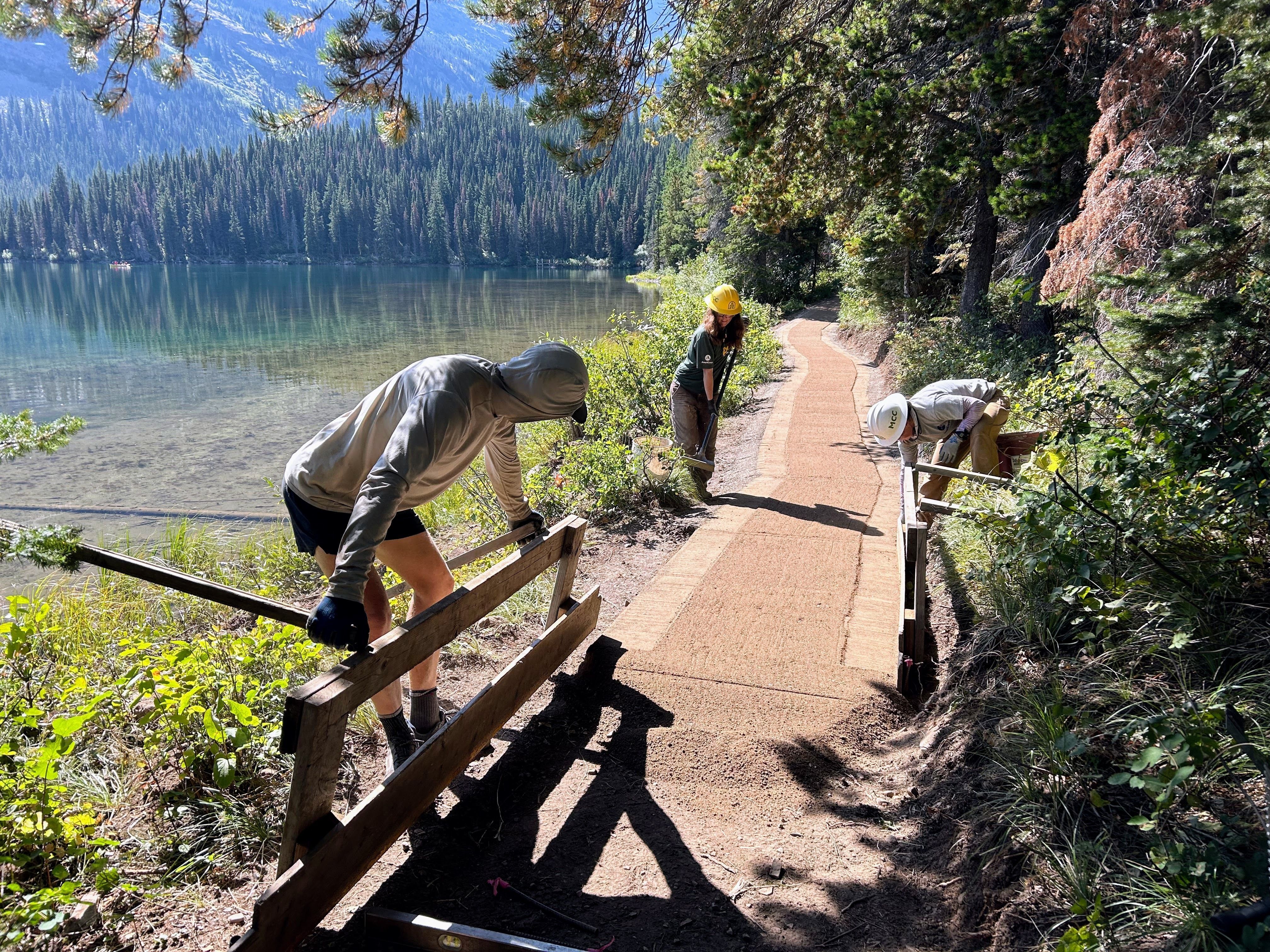 Crew members work on the swiftcurrent trail.