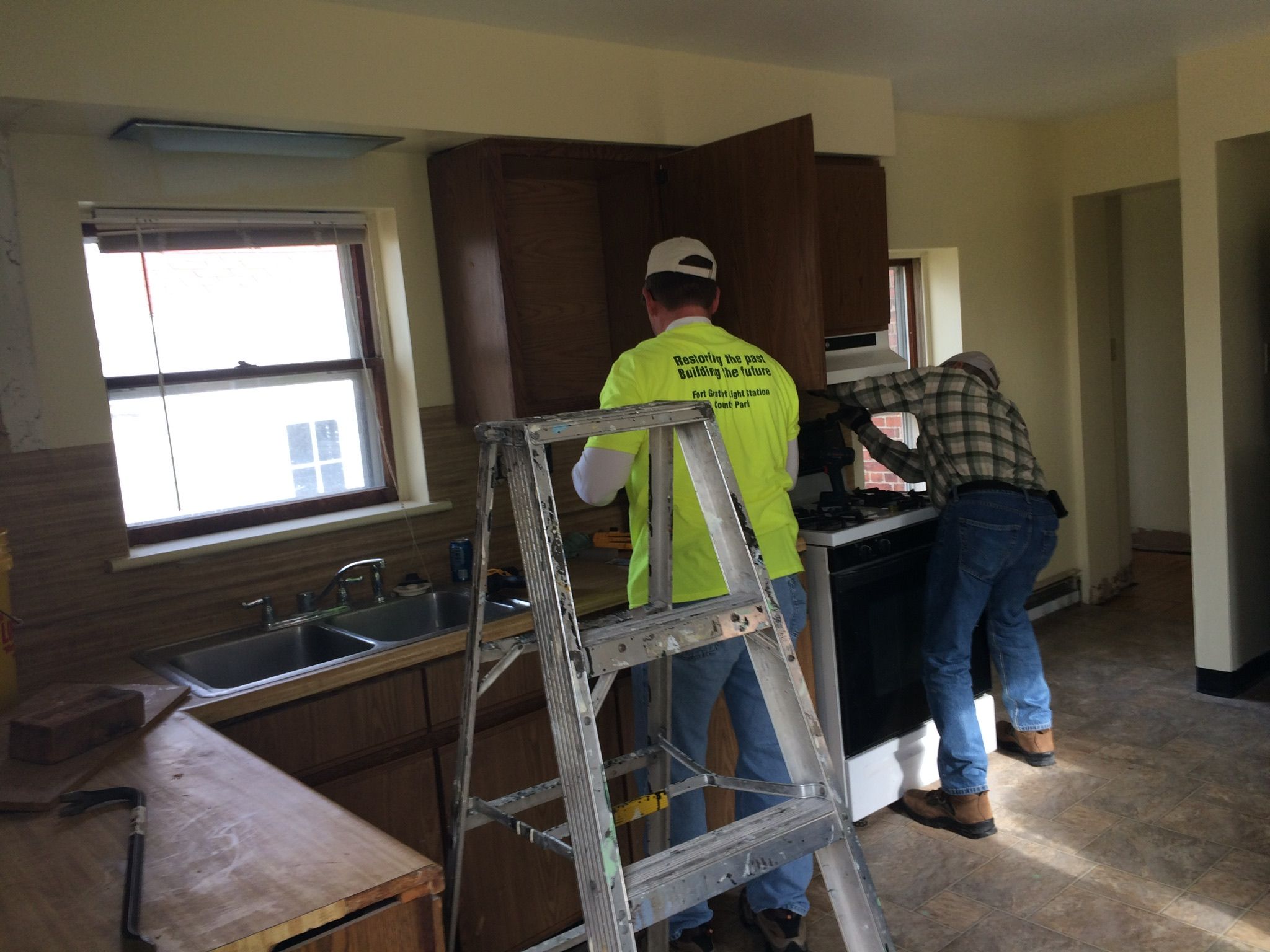 Taking out cabinets in the kitchen of the Duplex