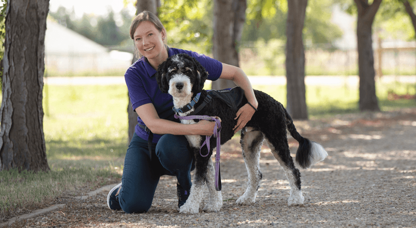 Leah and Facility Dog Cosmo on trail
