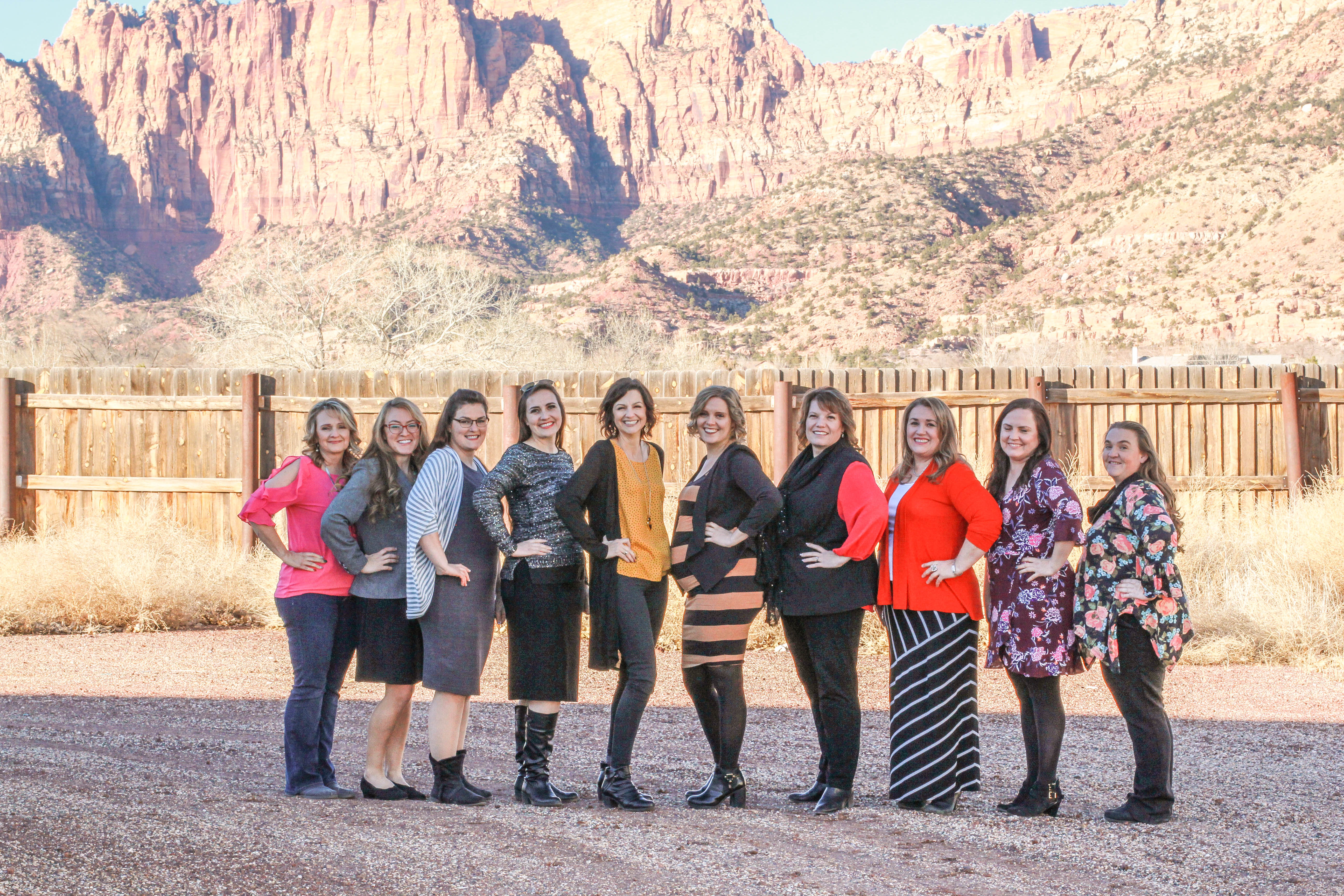 Cherish Families staff posing in front of the beautiful red mountains of Southern Utah