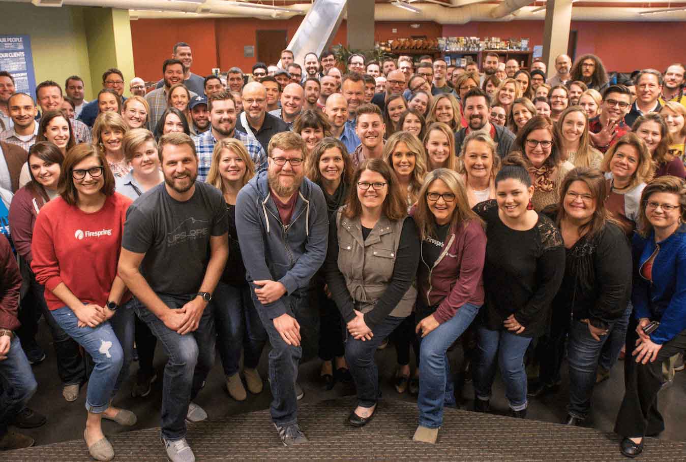 Firespring team members partake in a large group selfie.