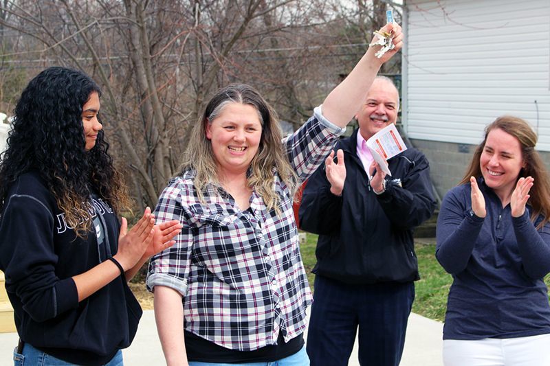 Ivonne Mangold is handed the keys to her new Dayton Habitat home.