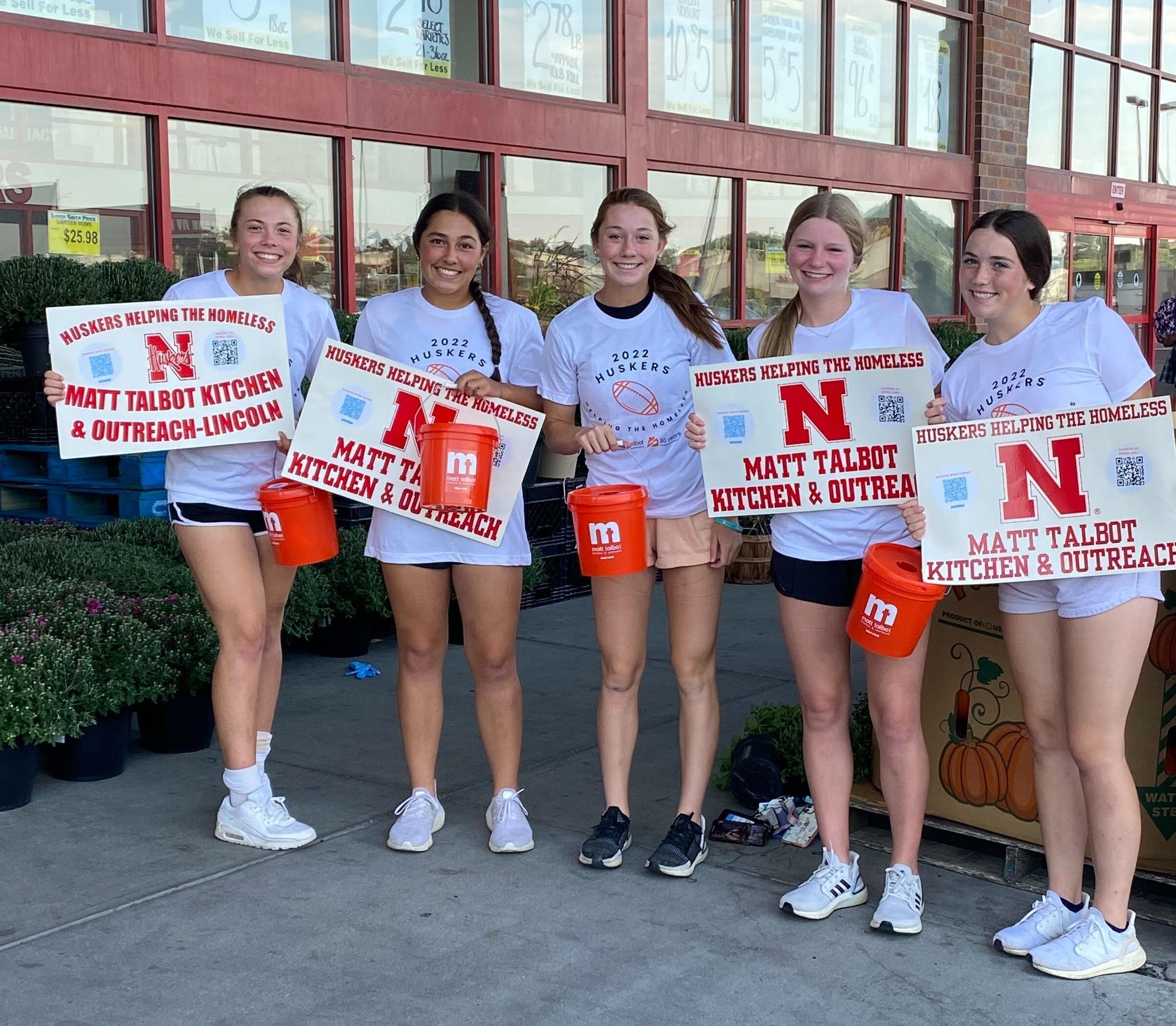 Five members of the Lincoln Southwest High School Softball Team collect donations outside of Super Saver. 