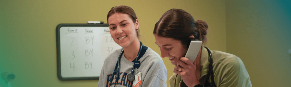 nursing students smiling while one is on phone