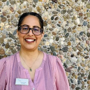 Smiling woman with dark hair and Araceli nametag